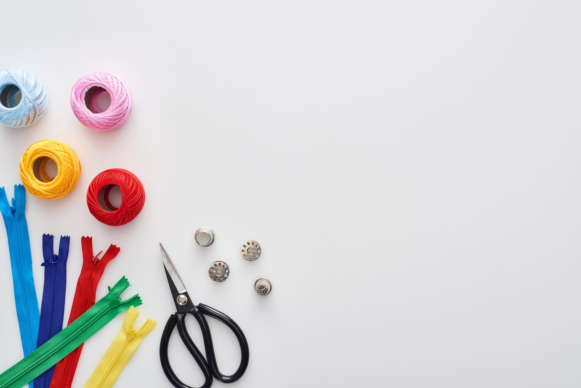 Flatlay of embroidery tools and threads