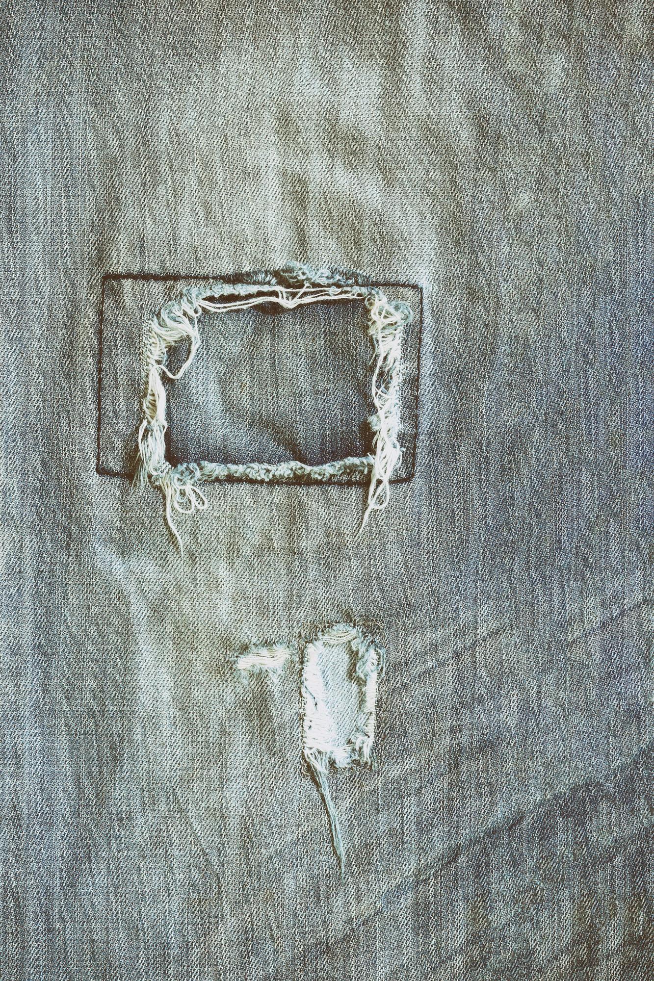 Worn embroidered patch before retouch